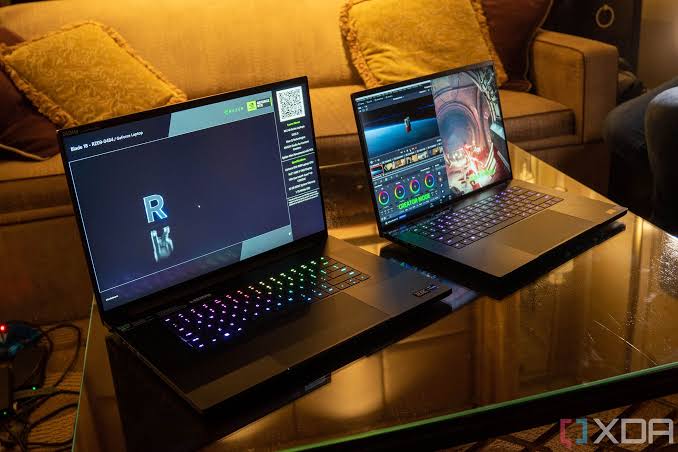 Front-facing view of an open black Razer Blade 18 laptop, showcasing its massive 18-inch 16:10 display with slim bezels and vibrant desktop wallpaper.